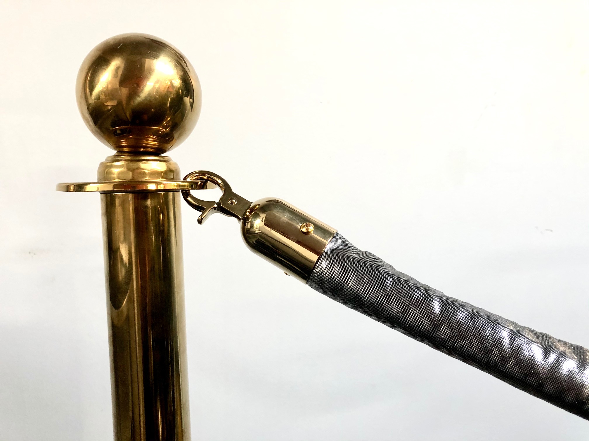 Brass stanchion with black rope